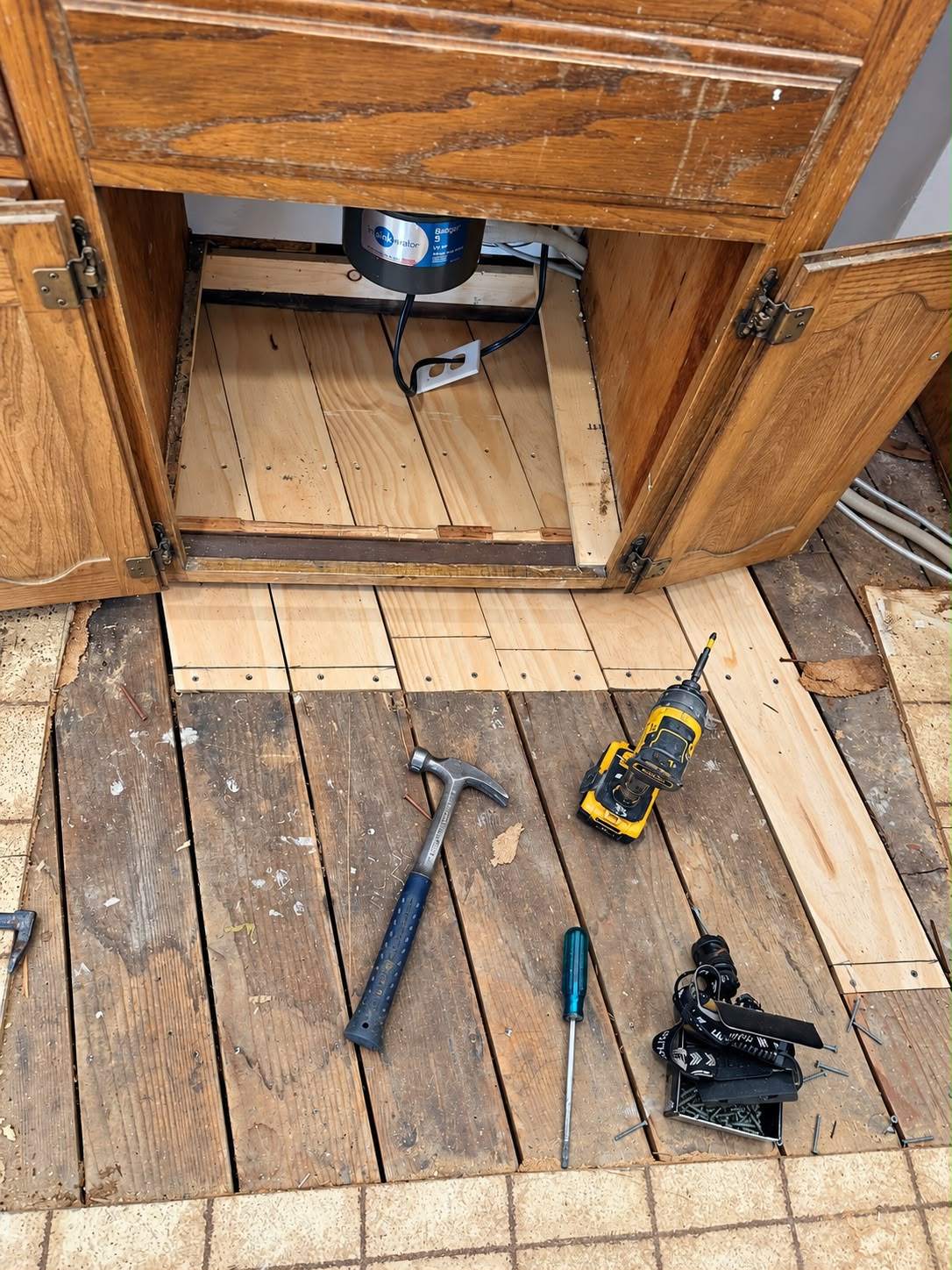 New wood installed beneath the sink cabinet and adjoining subfloor