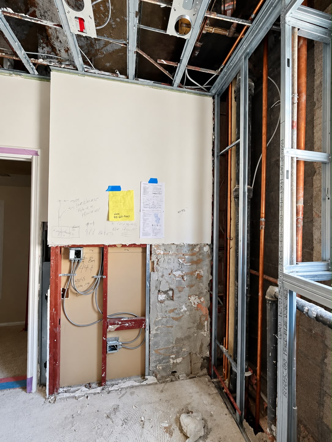 Before: Doorway and exposed wall framing