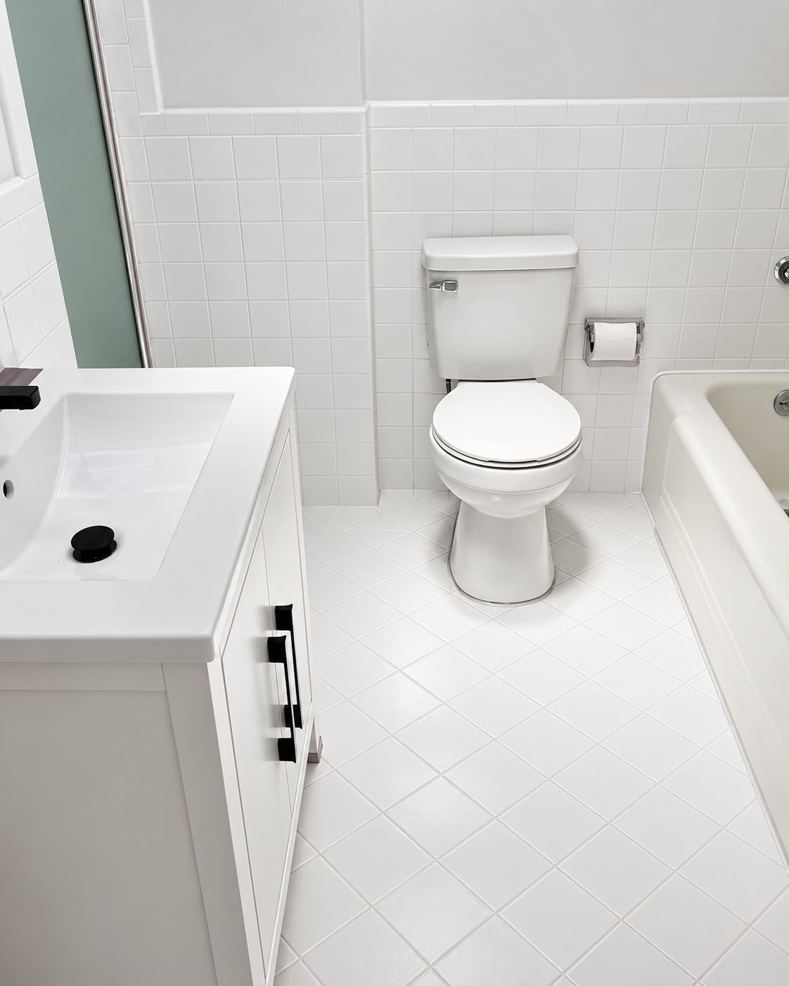 Bathroom fixtures with a white vanity, toilet, and tile finish details
