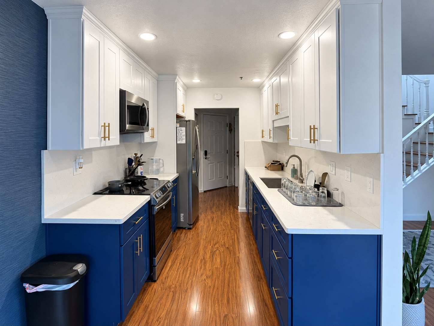 Full kitchen view with white upper and navy blue lower cabinets